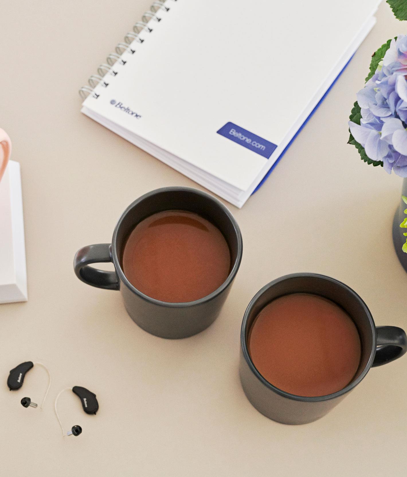 hearing aids placing next to coffee in hearing care professional clinic
