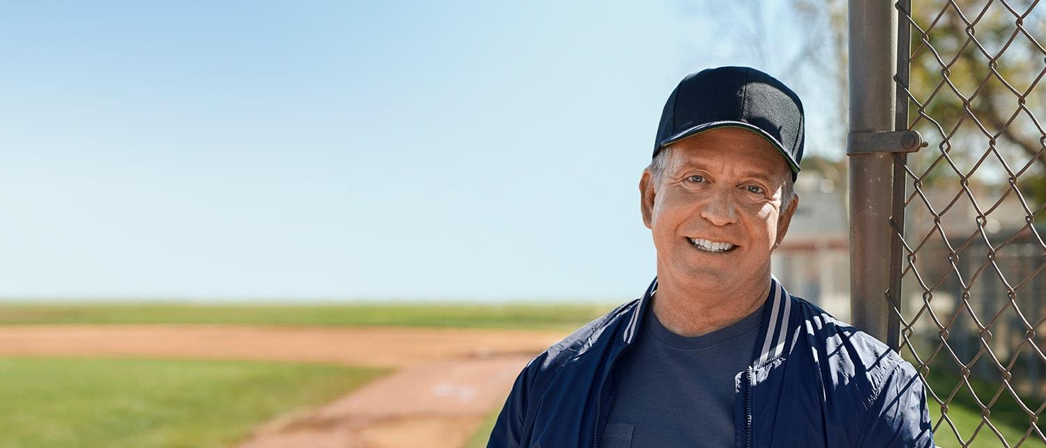 Baseball coach smiling and happy for his new Beltone Amaze hearing aids