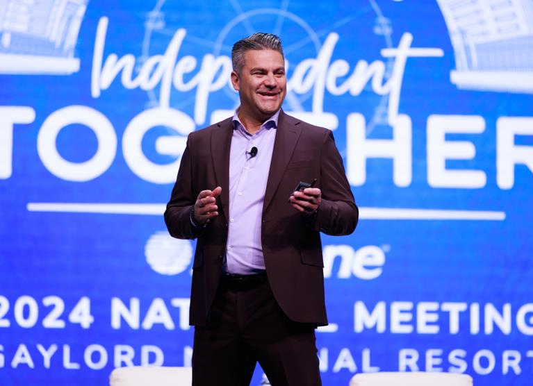 hearing aids being described on stage by speaker at national meeting