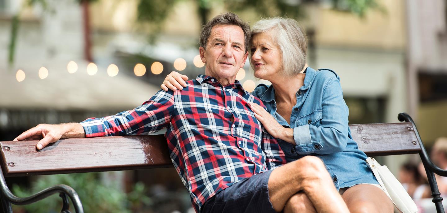 man and woman sitting on a bench