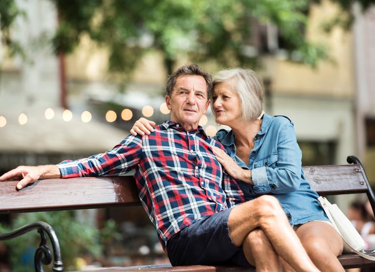 man and woman sitting on a bench